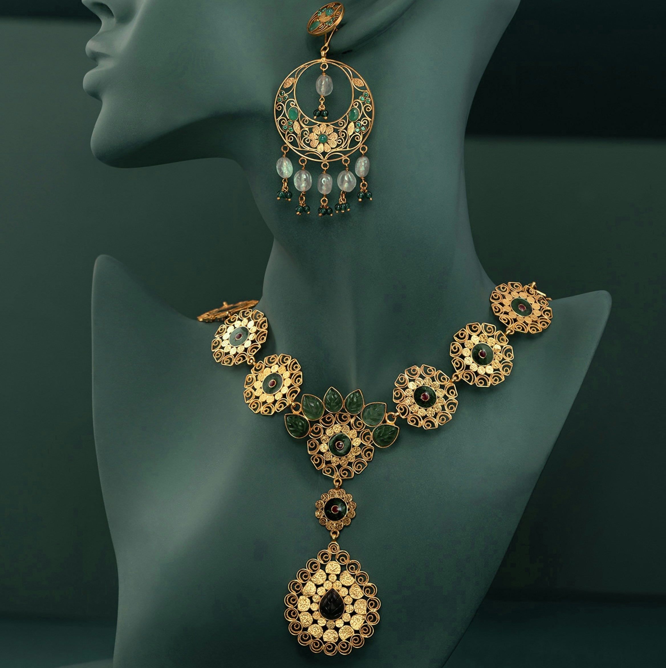 Gold necklace and earrings on a mannequin bust against a dark background